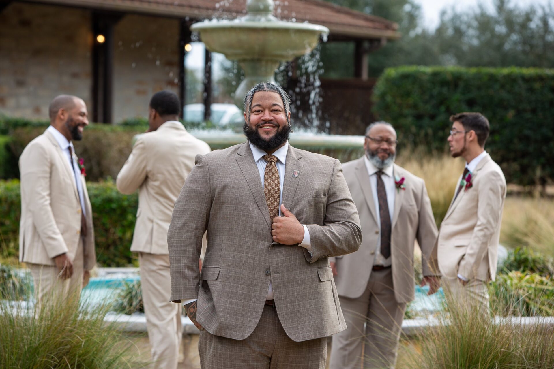 Thomas and his groomsmen by the courtyard fountain
