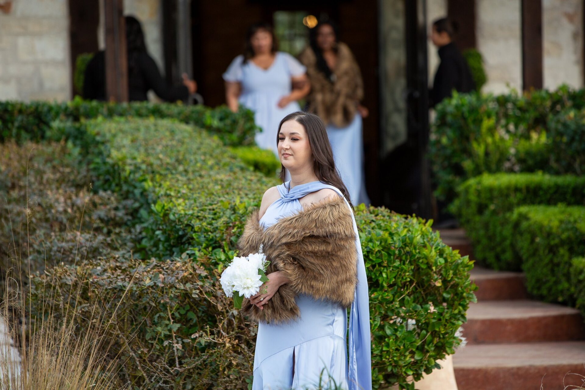 Bridesmaid holding a bouquet before the ceremony