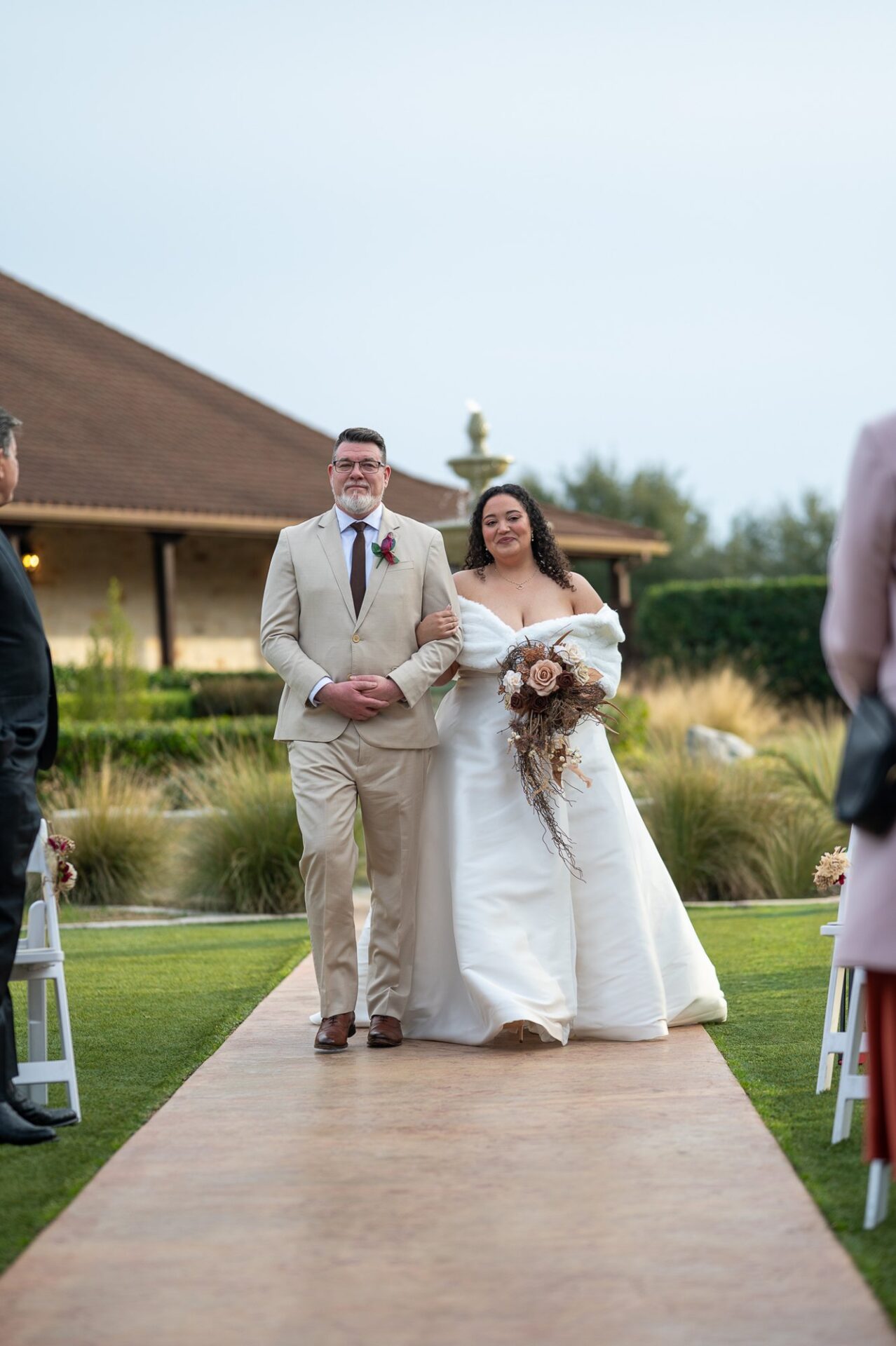 Macee walking toward the outdoor ceremony