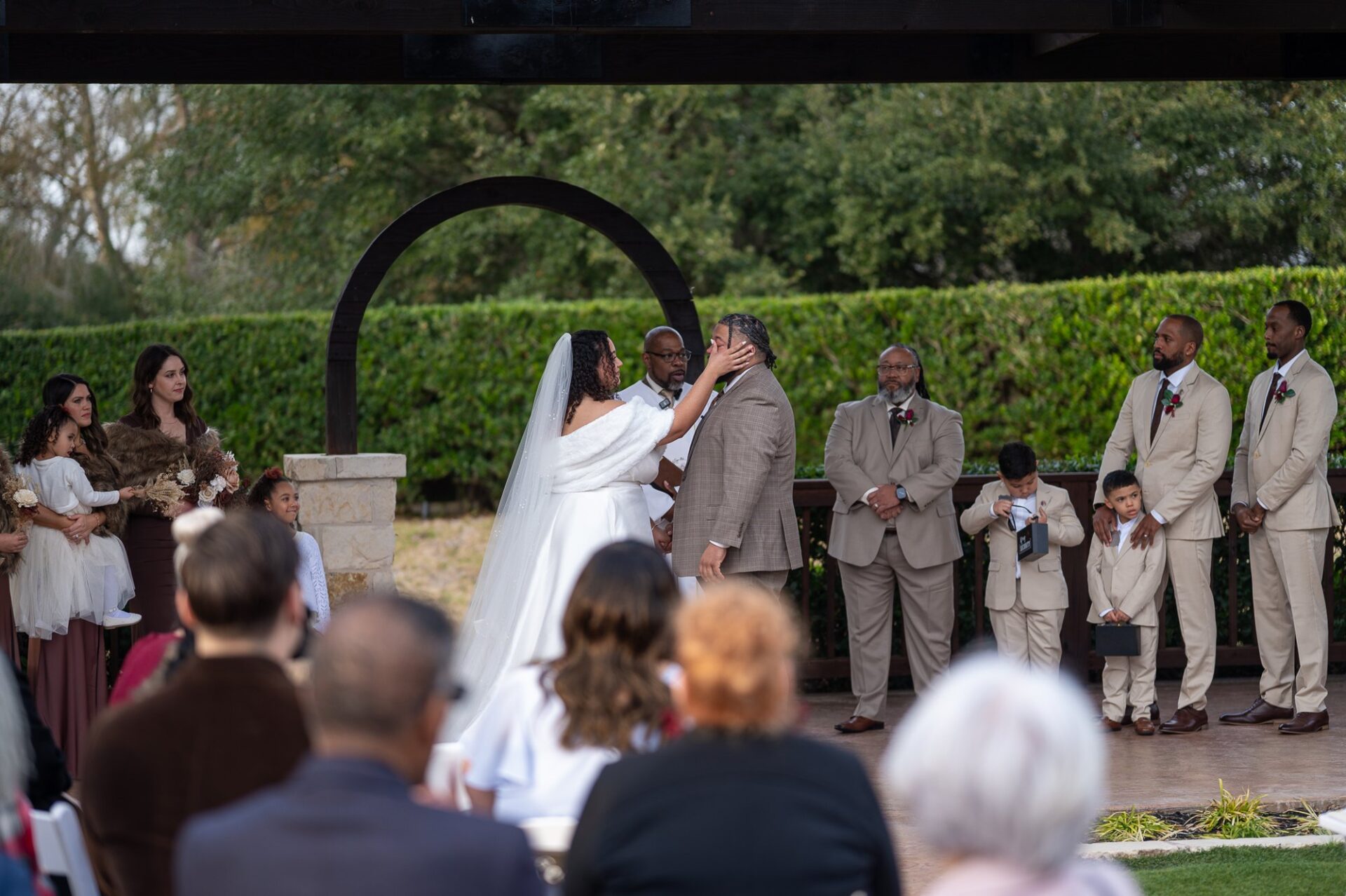 Thomas and Macee at the ceremony arch
