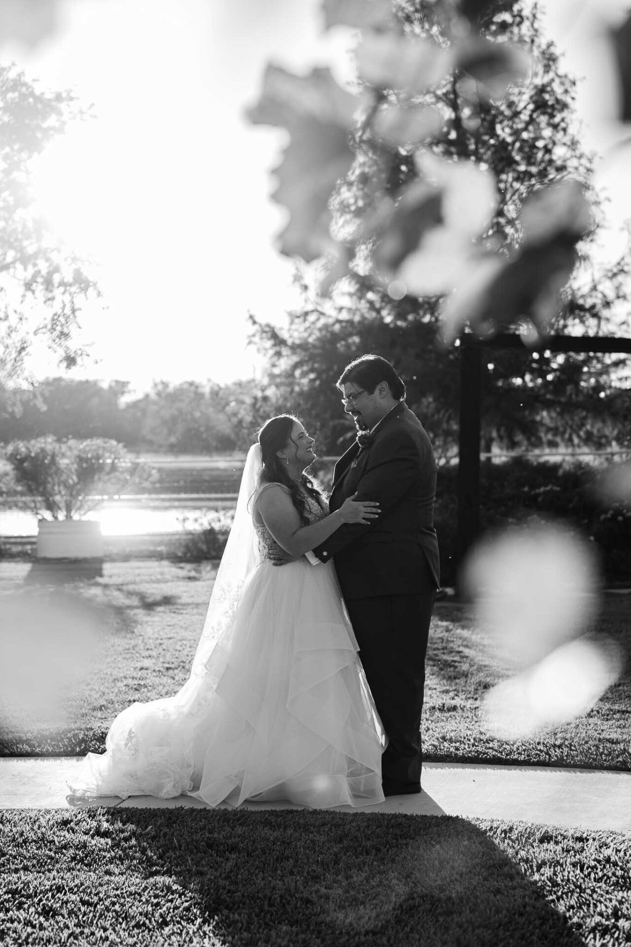 Black-and-white portrait of Andreea and Ram together at the ranch near sunset.