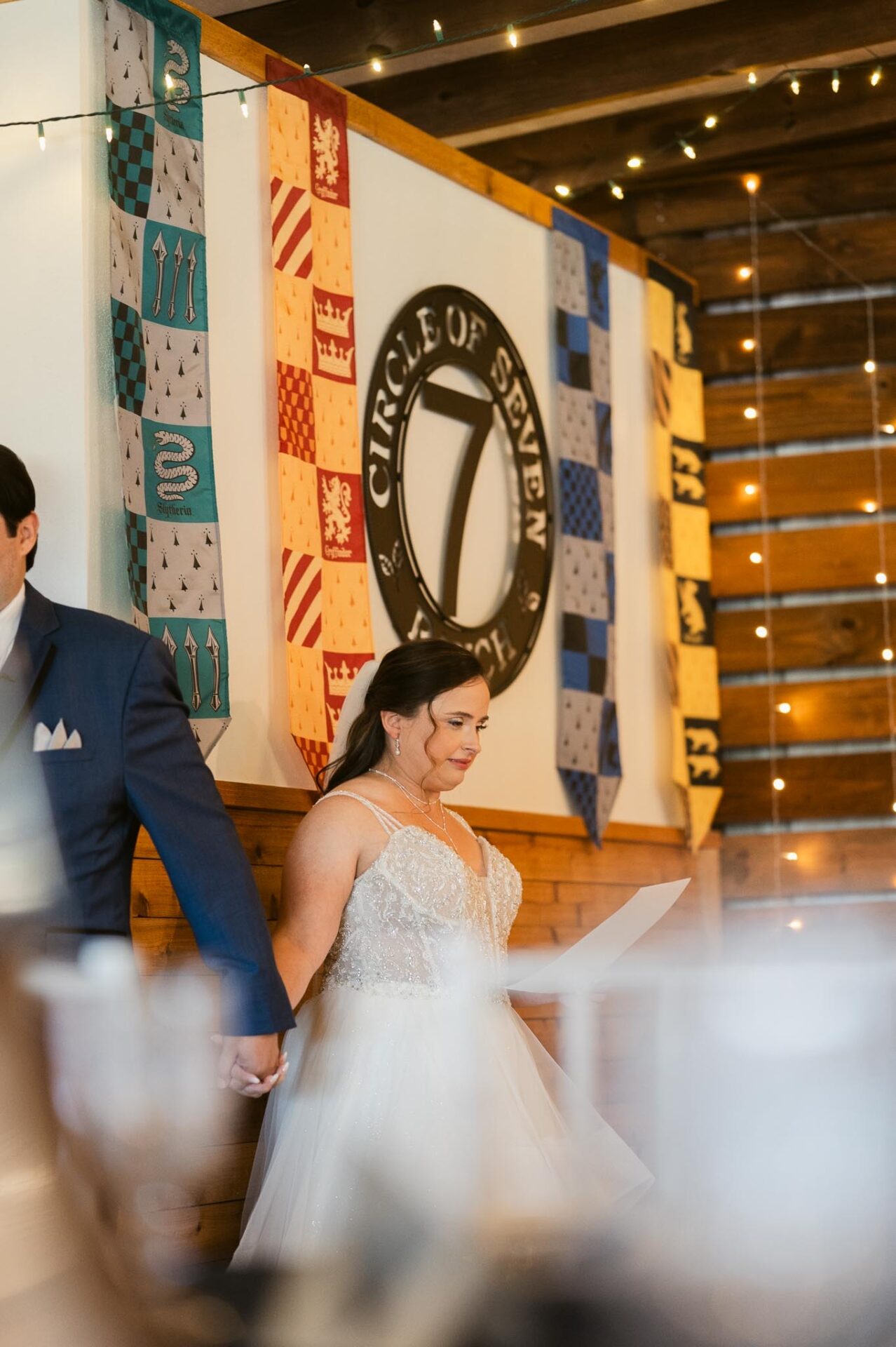 Andreea enters the ceremony beside Ram beneath the Circle of Seven Ranch pavilion.