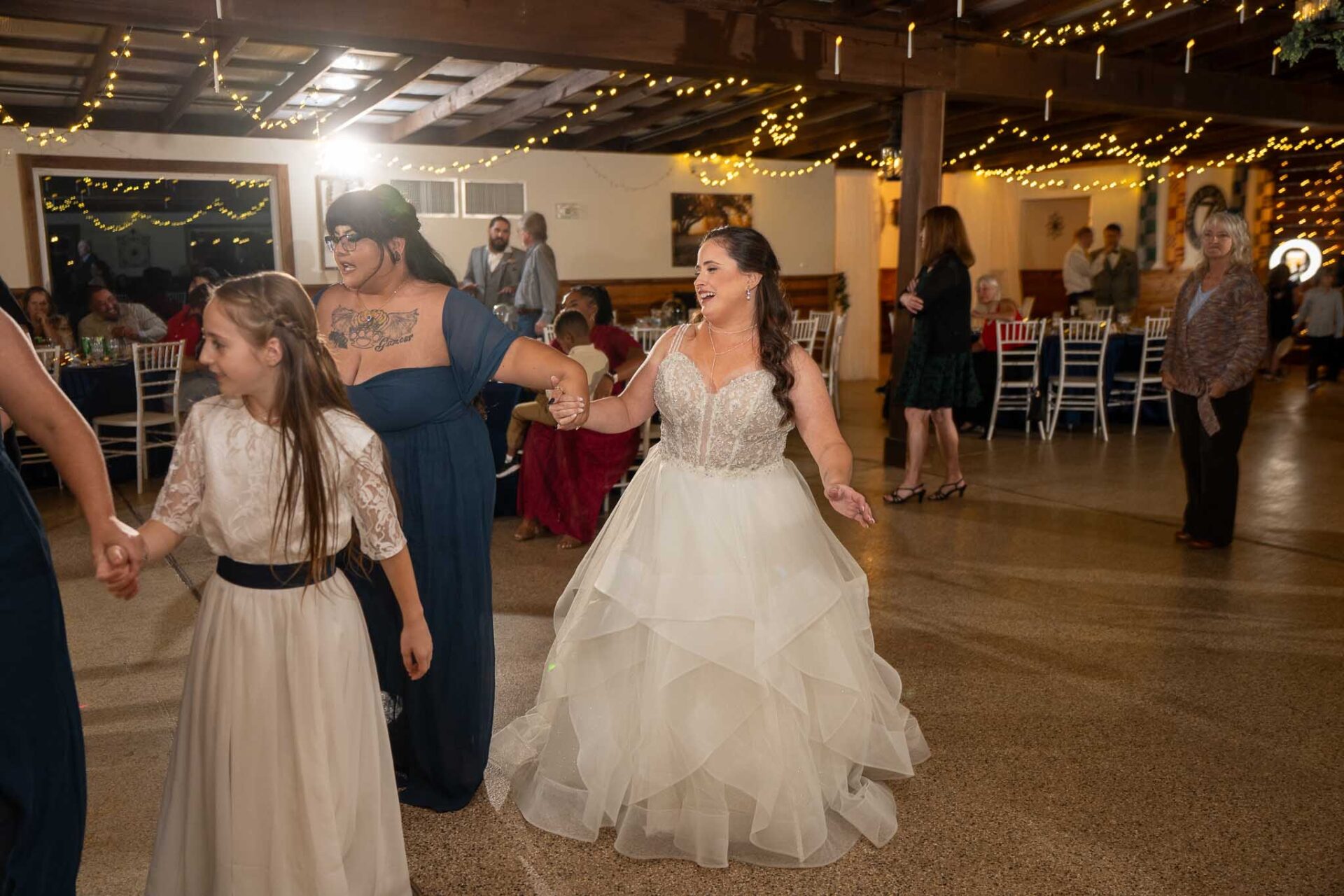 Andreea joins her guests on the dance floor under the reception hall lights.