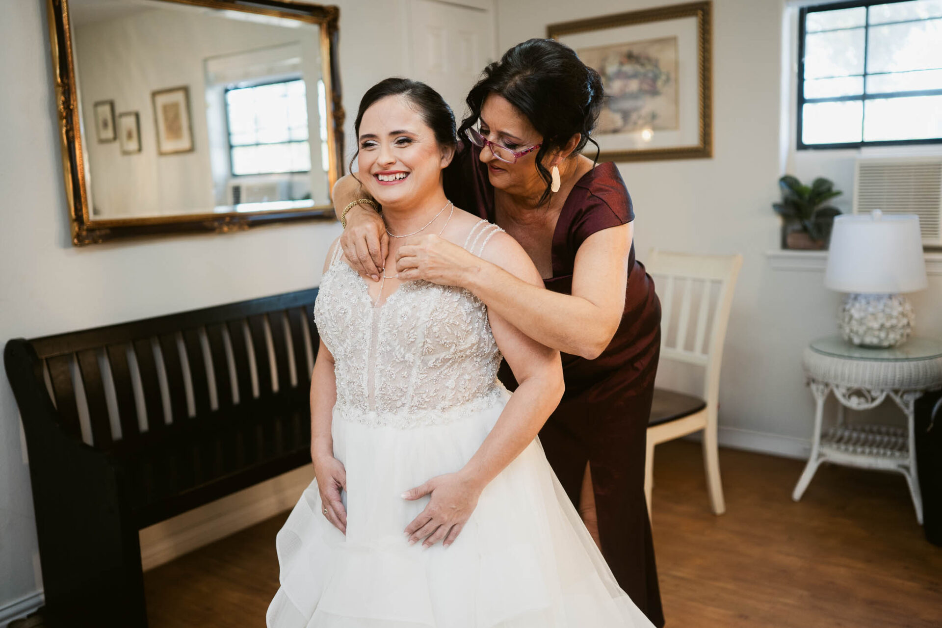 Andreea smiles as her mother helps her get ready in the bridal suite.