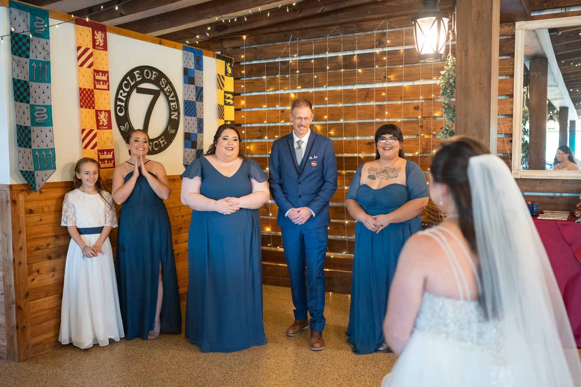 Andreea approaches the ceremony as her wedding party waits beneath the ranch pavilion.