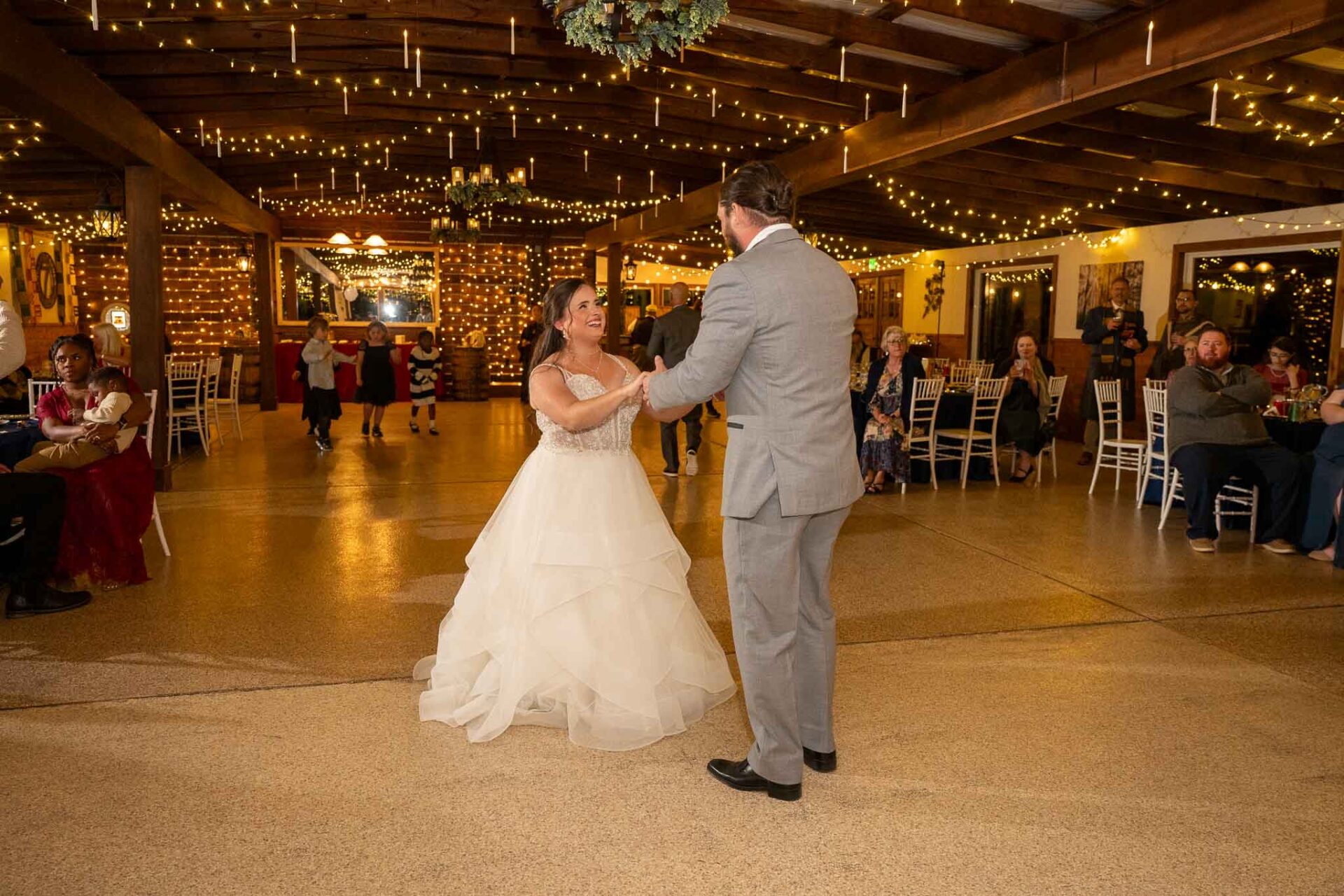 Andreea and Ram share their first dance as family and friends look on.