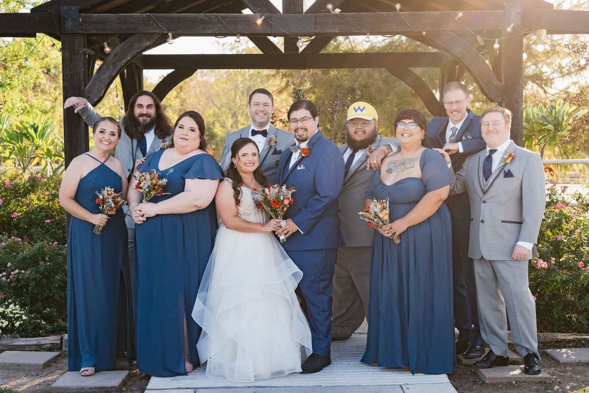 Andreea and Ram pose with their wedding party beneath the Circle of Seven Ranch gazebo.