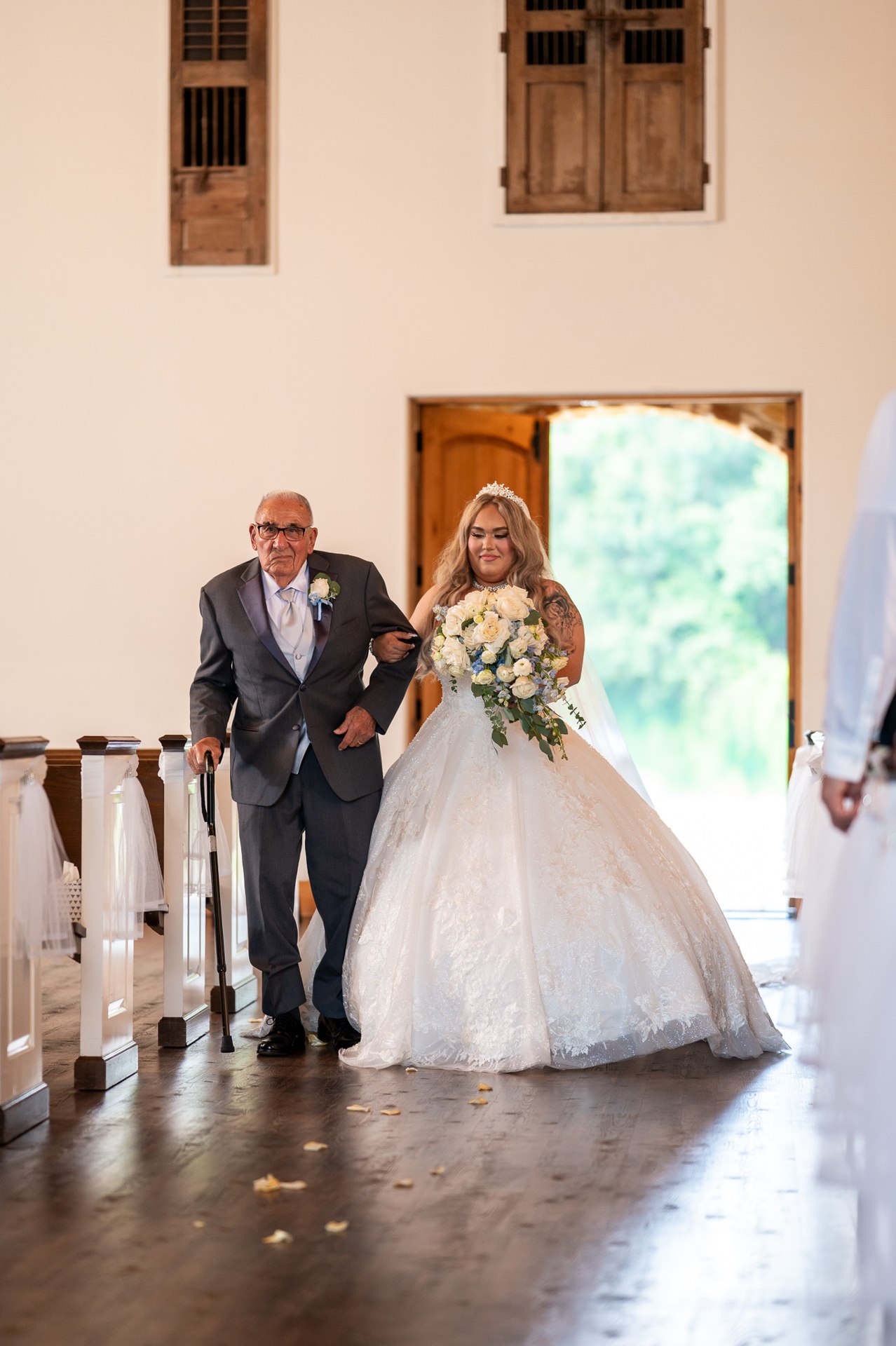 Marissa entering the chapel with her escort
