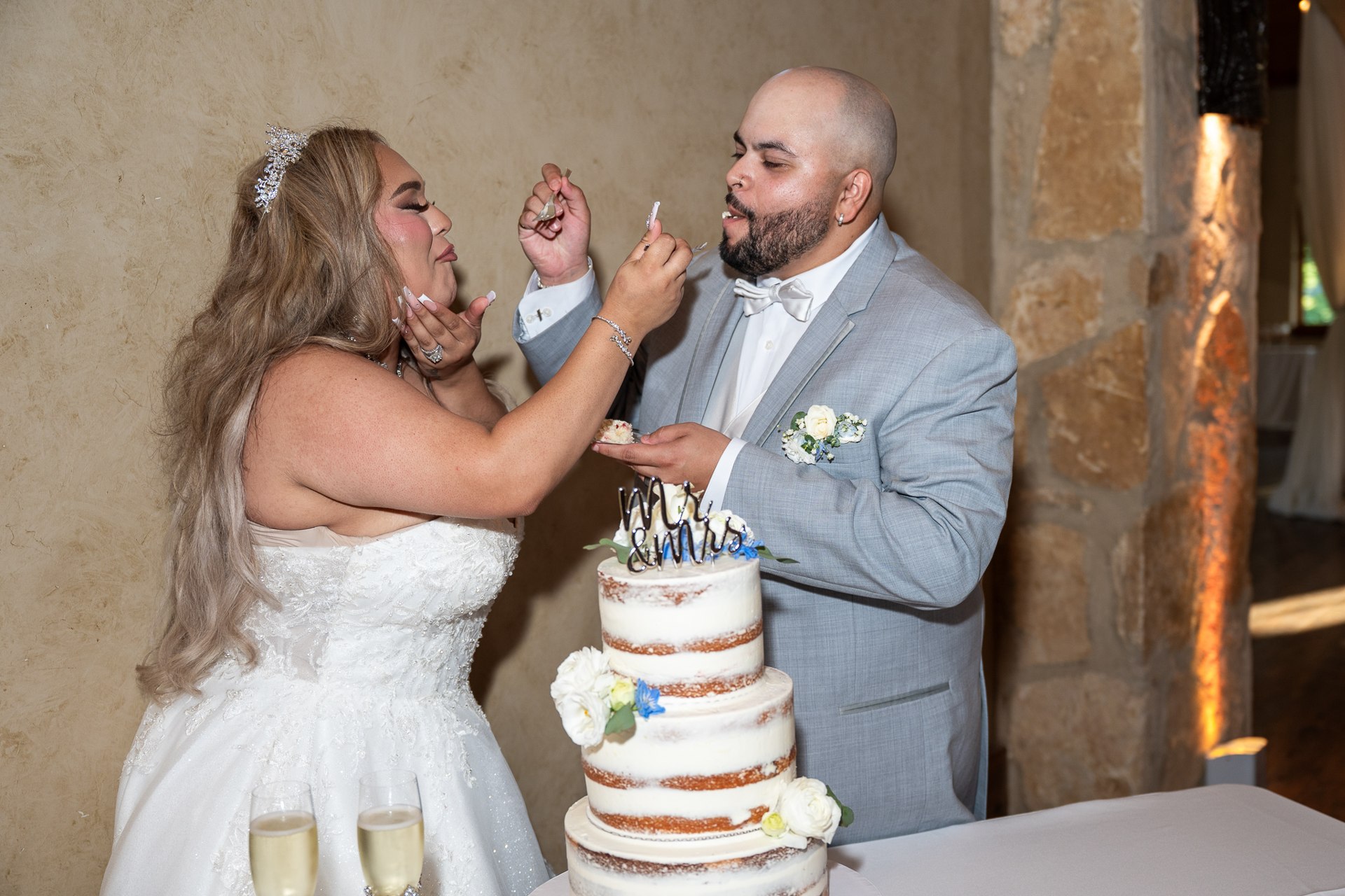 Elijah and Marissa sharing cake during their reception