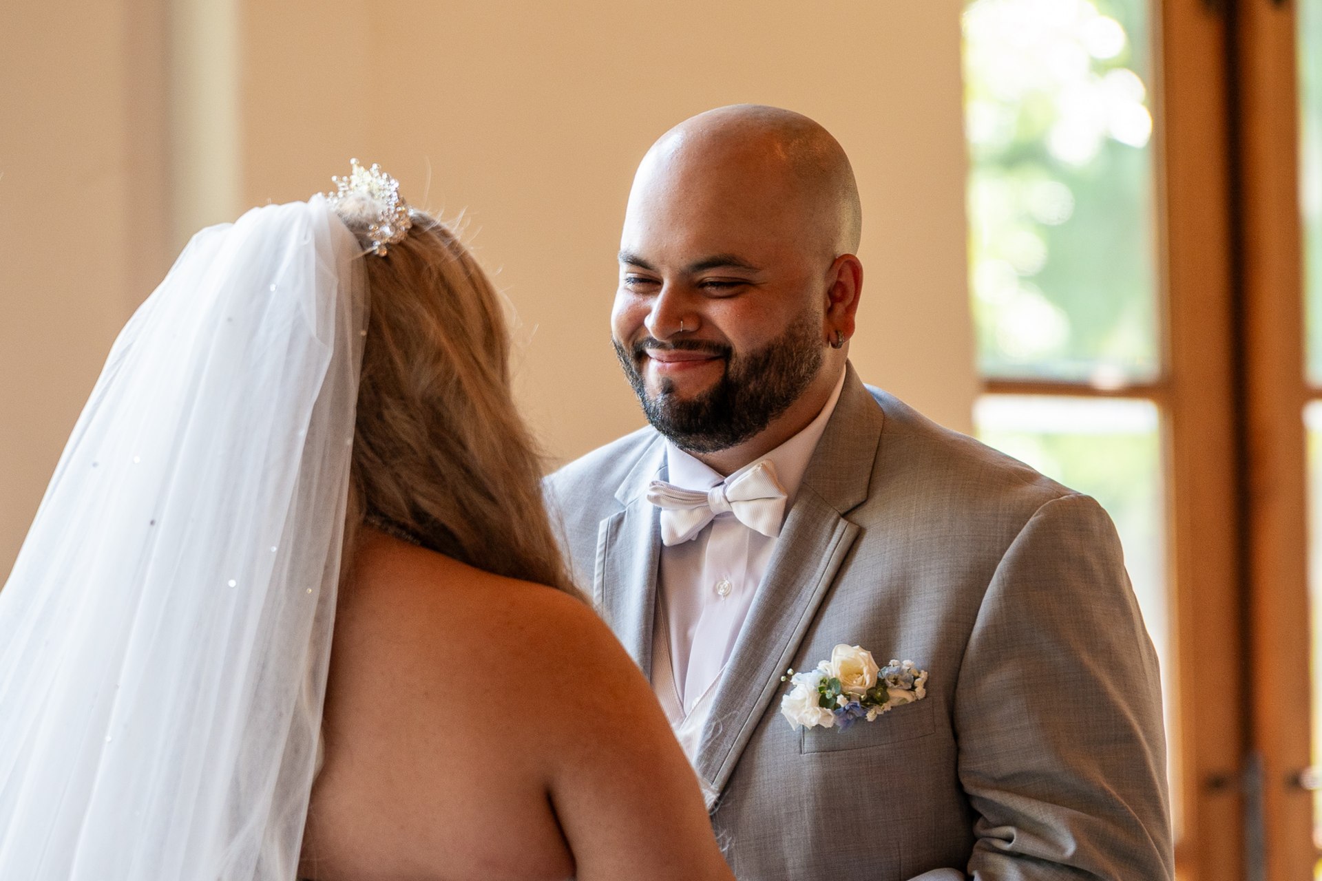 Elijah smiling toward Marissa during their ceremony