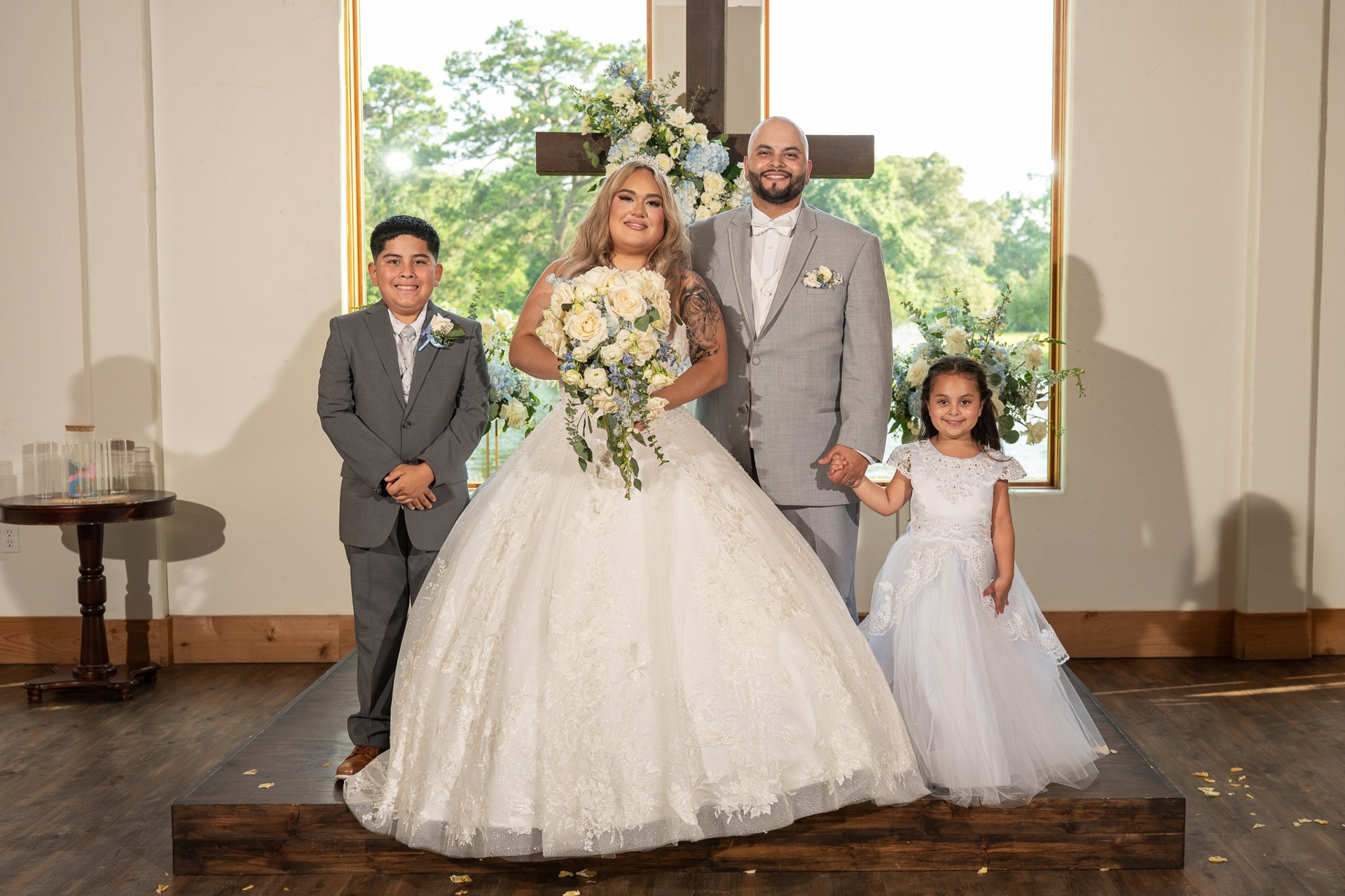 Elijah and Marissa posing with two children in the chapel