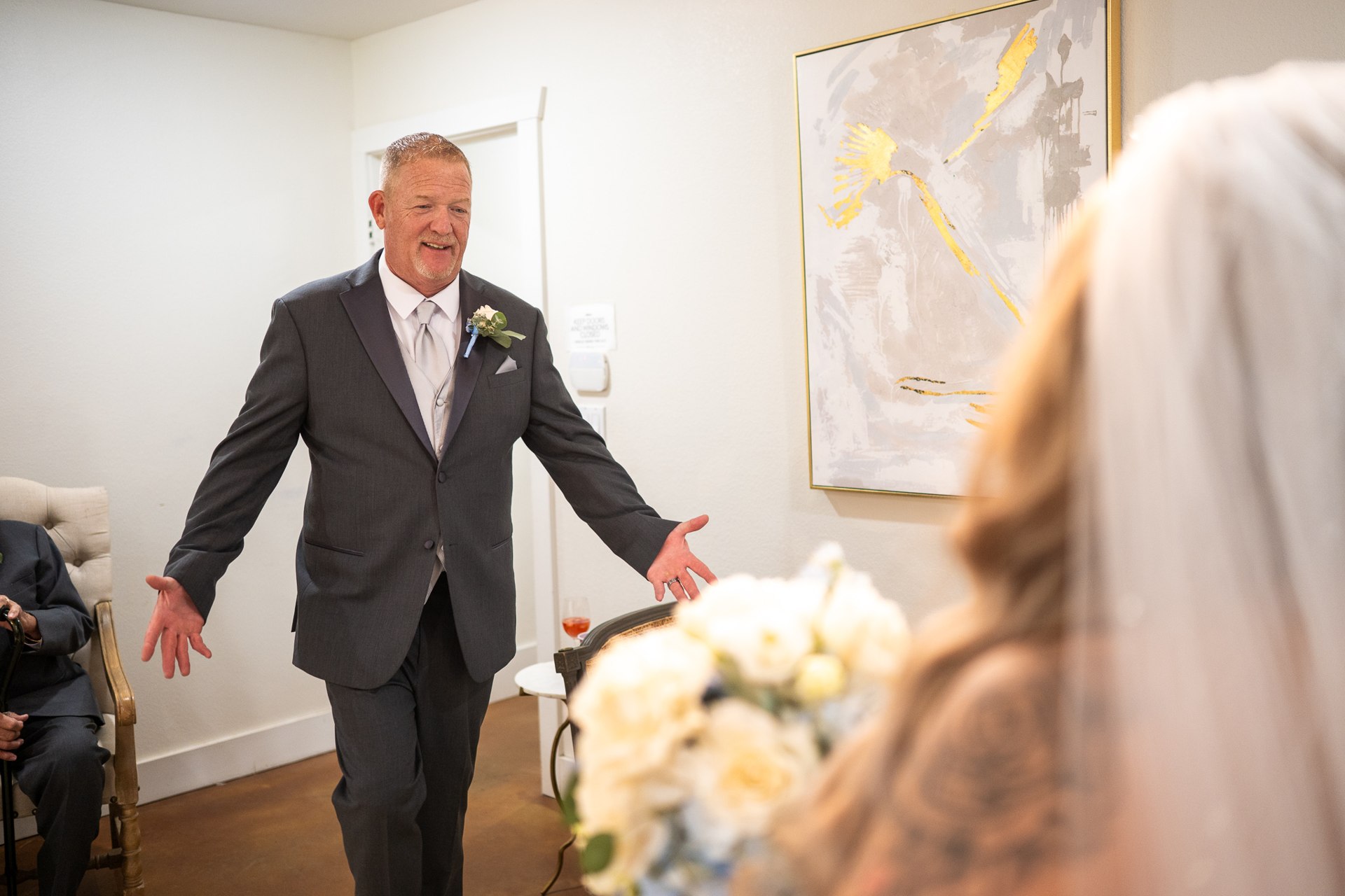 A family member opening his arms toward Marissa