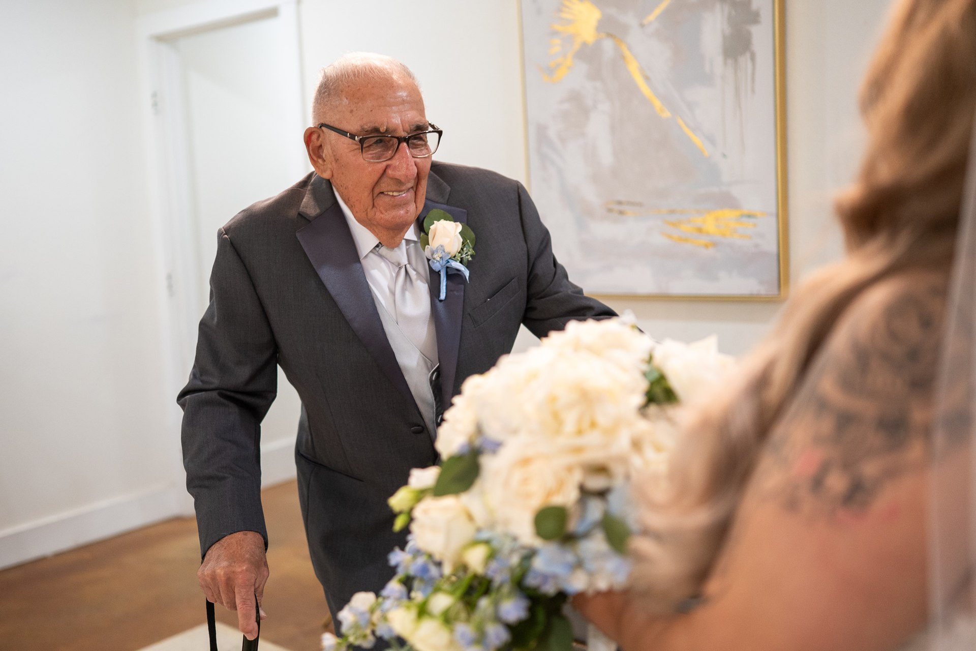 A family member smiling as he sees Marissa in her wedding dress