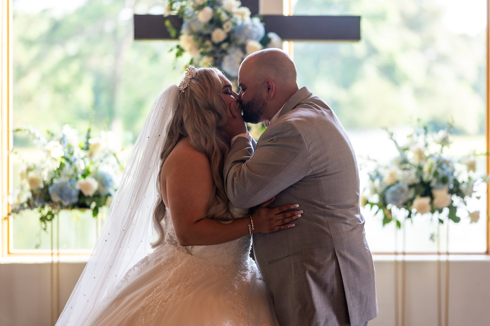 Elijah and Marissa kissing at the chapel altar