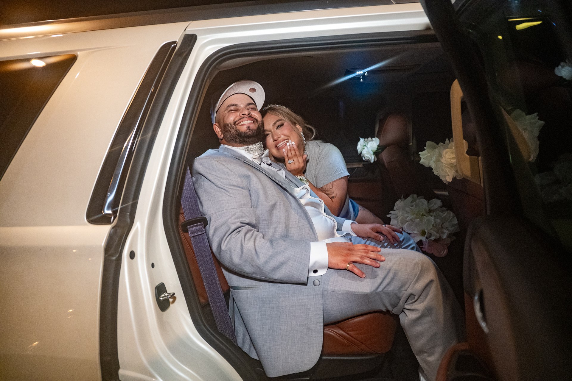 Elijah and Marissa smiling together in their getaway vehicle