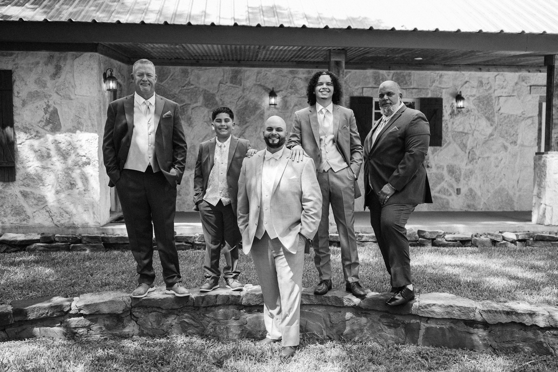 Elijah and his group posing outside in black and white