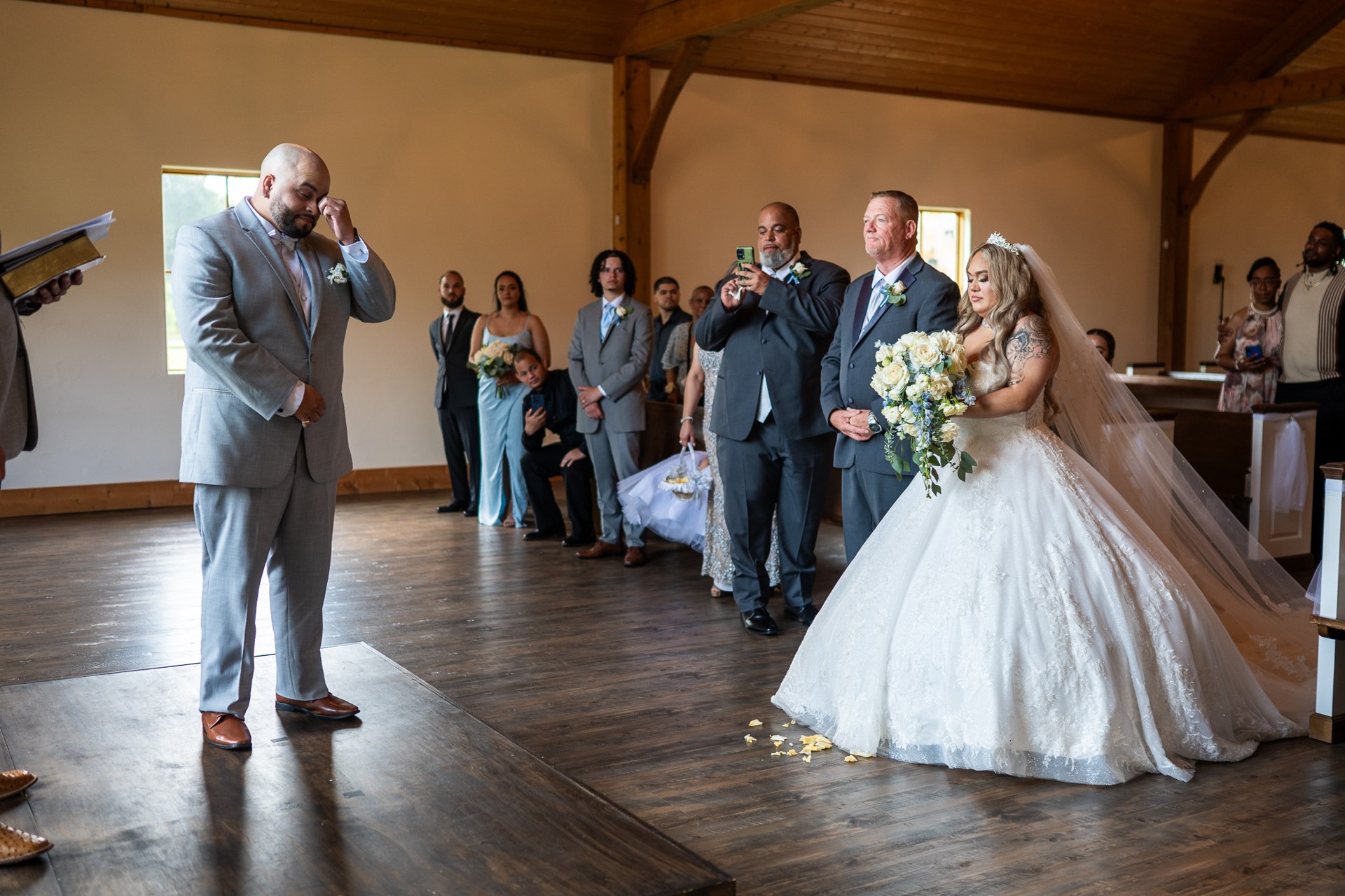 Elijah wiping his eye as Marissa approaches during the ceremony