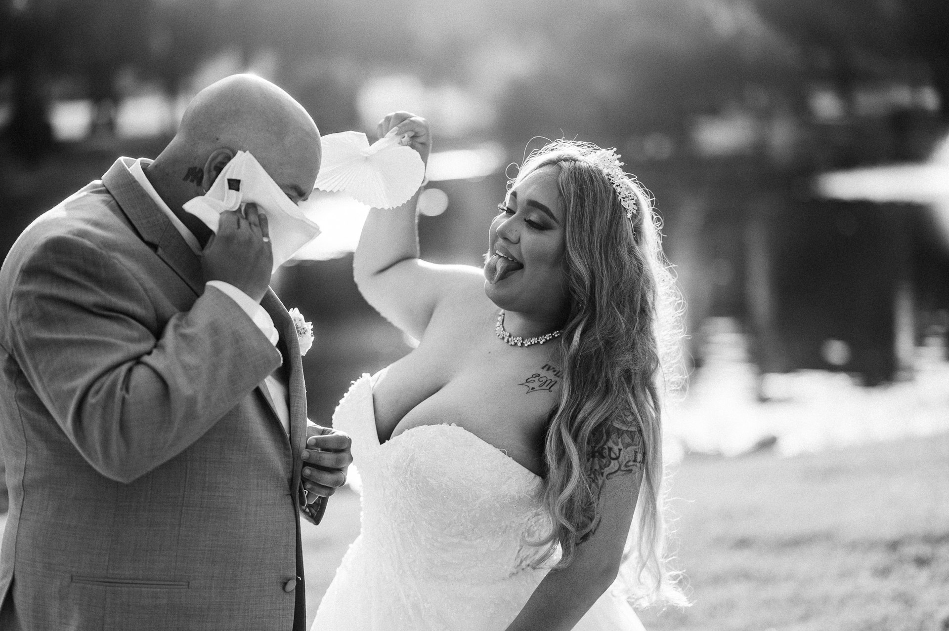 Elijah and Marissa laughing together in a black-and-white outdoor portrait