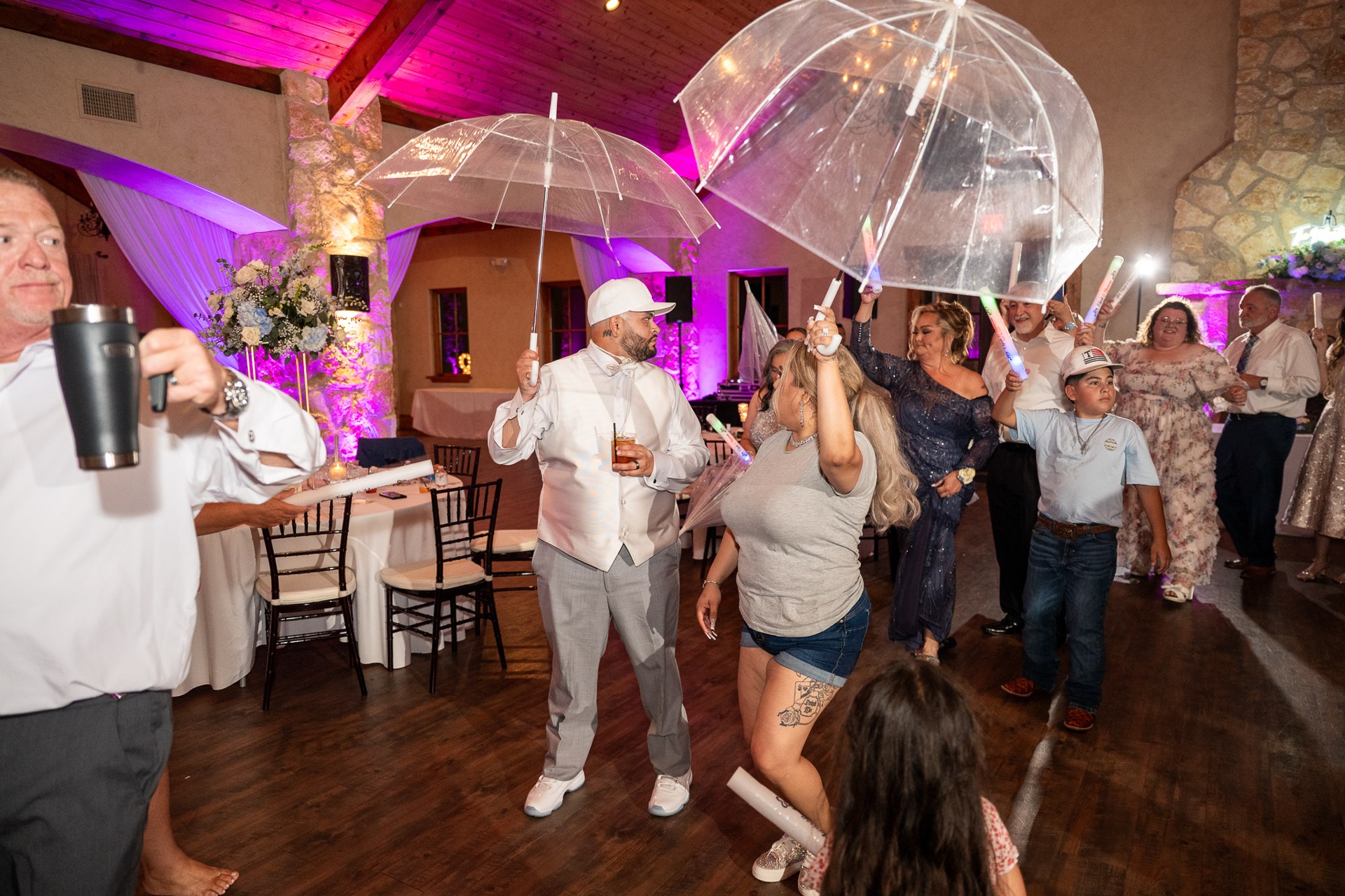 Guests dancing with clear umbrellas during the wedding reception