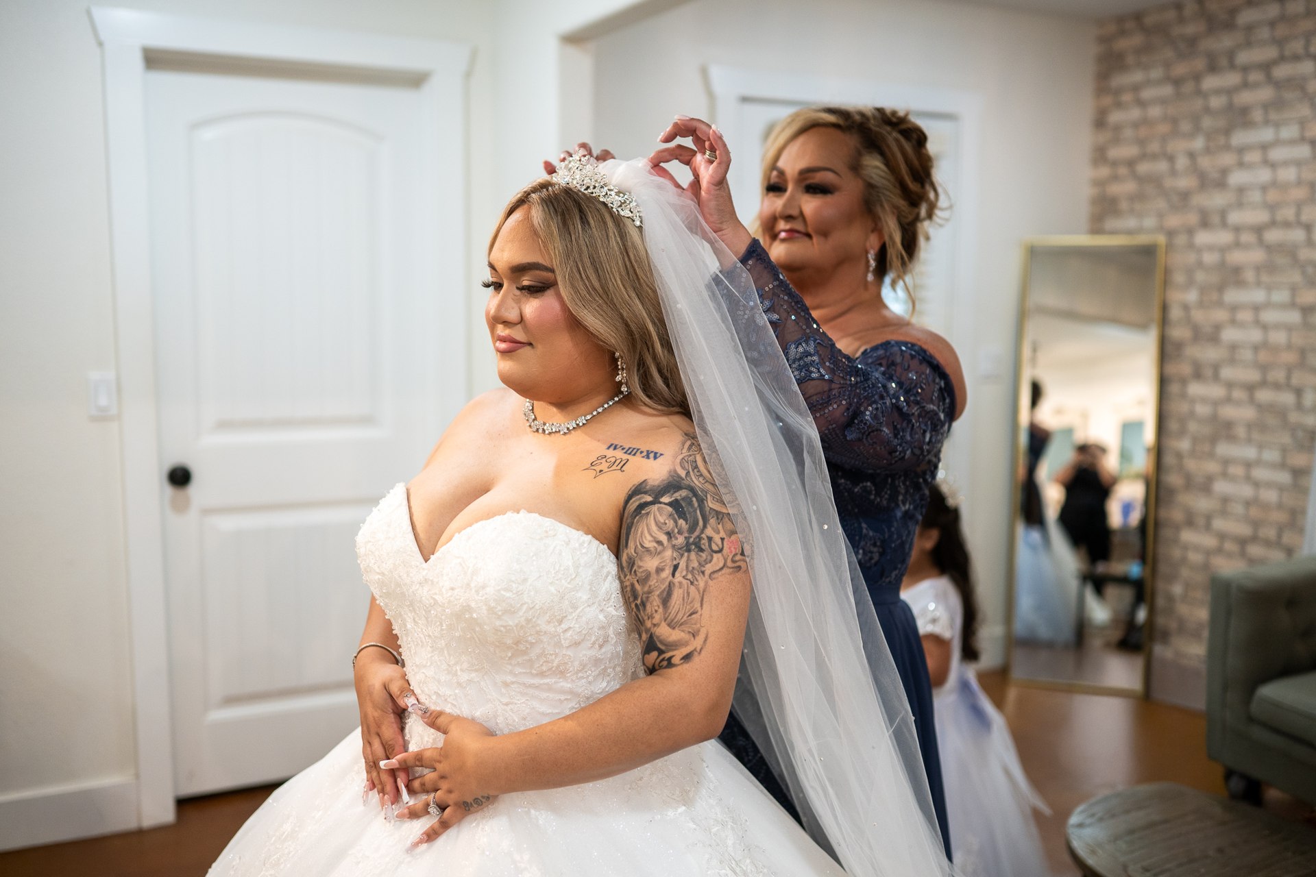 Marissa having her veil placed before the ceremony