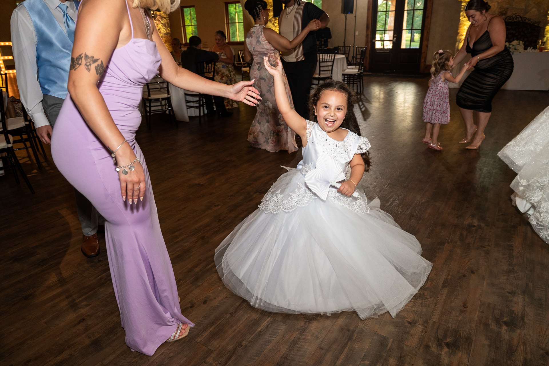 A young guest smiling and twirling on the dance floor
