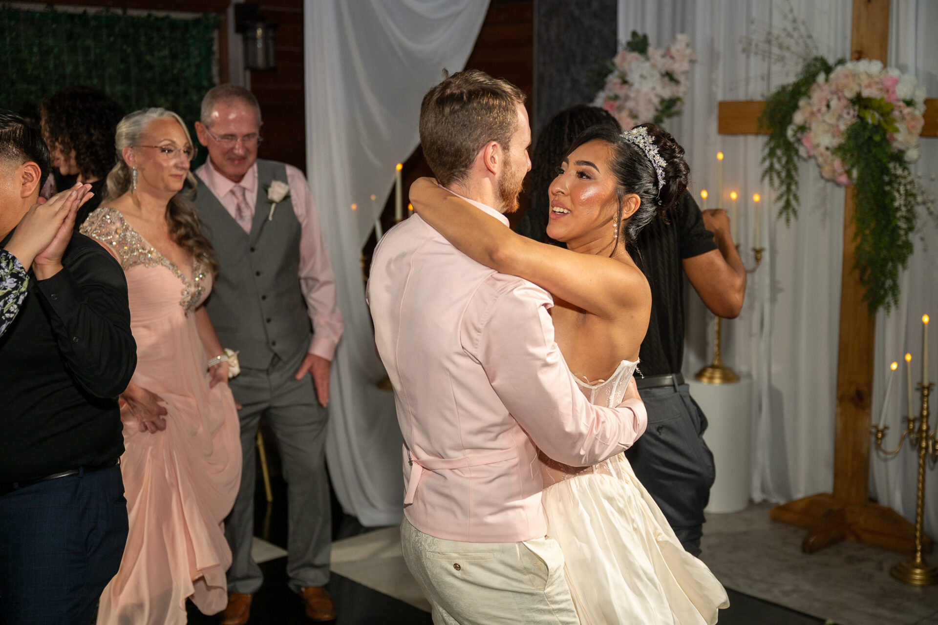 Grisel and Zachary dancing among their wedding guests