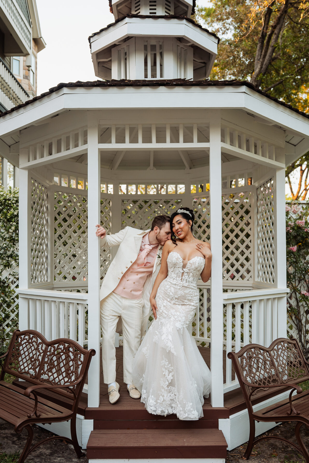 Grisel and Zachary sharing a playful portrait in the white garden gazebo