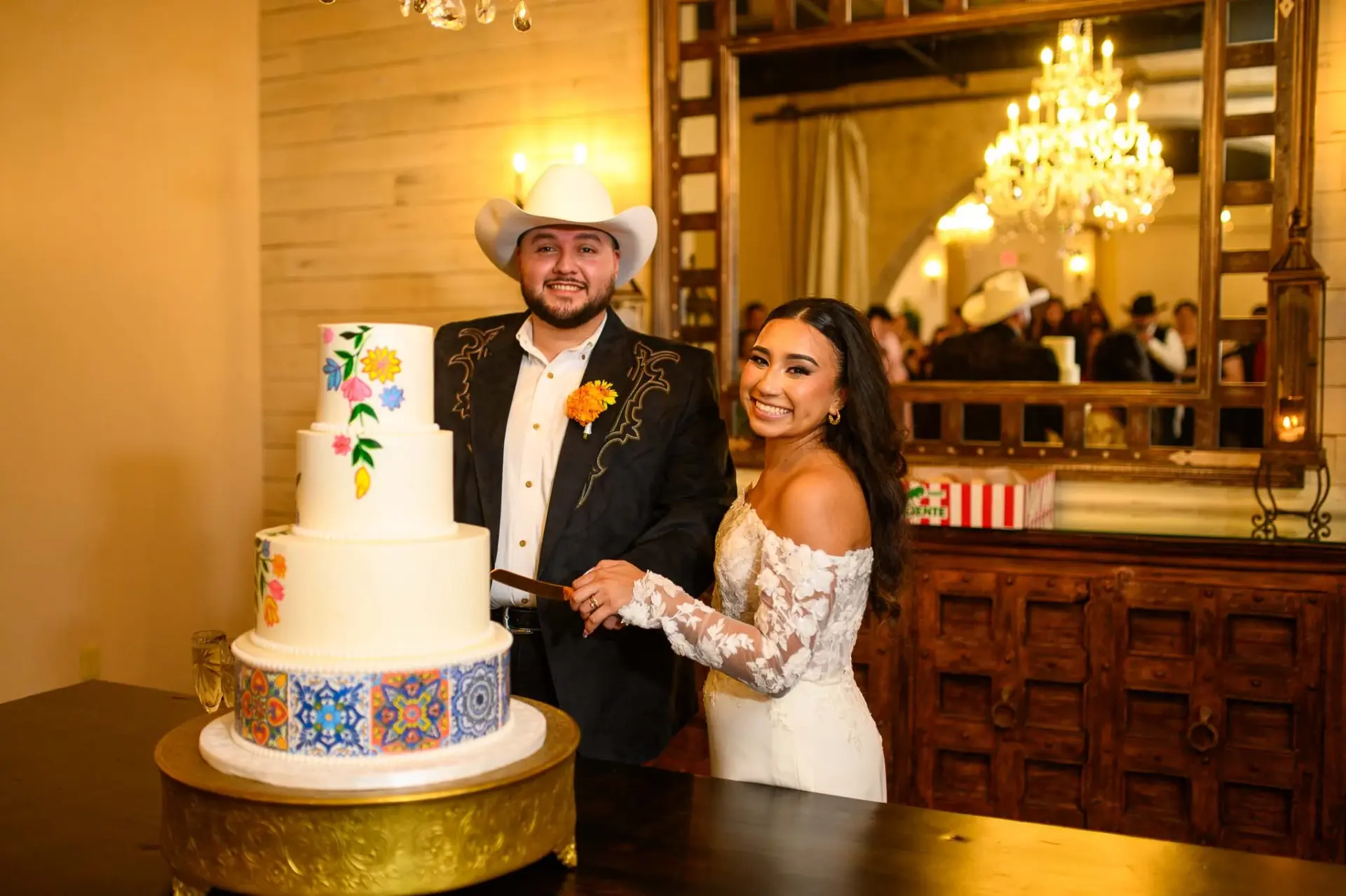 Vanessa and Reymundo cutting their wedding cake