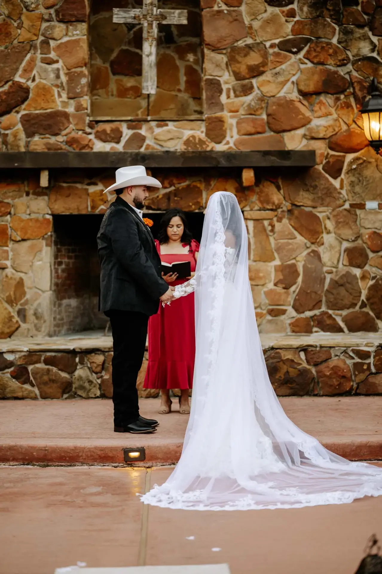 Vanessa and Reymundo during their ceremony in front of the stone backdrop