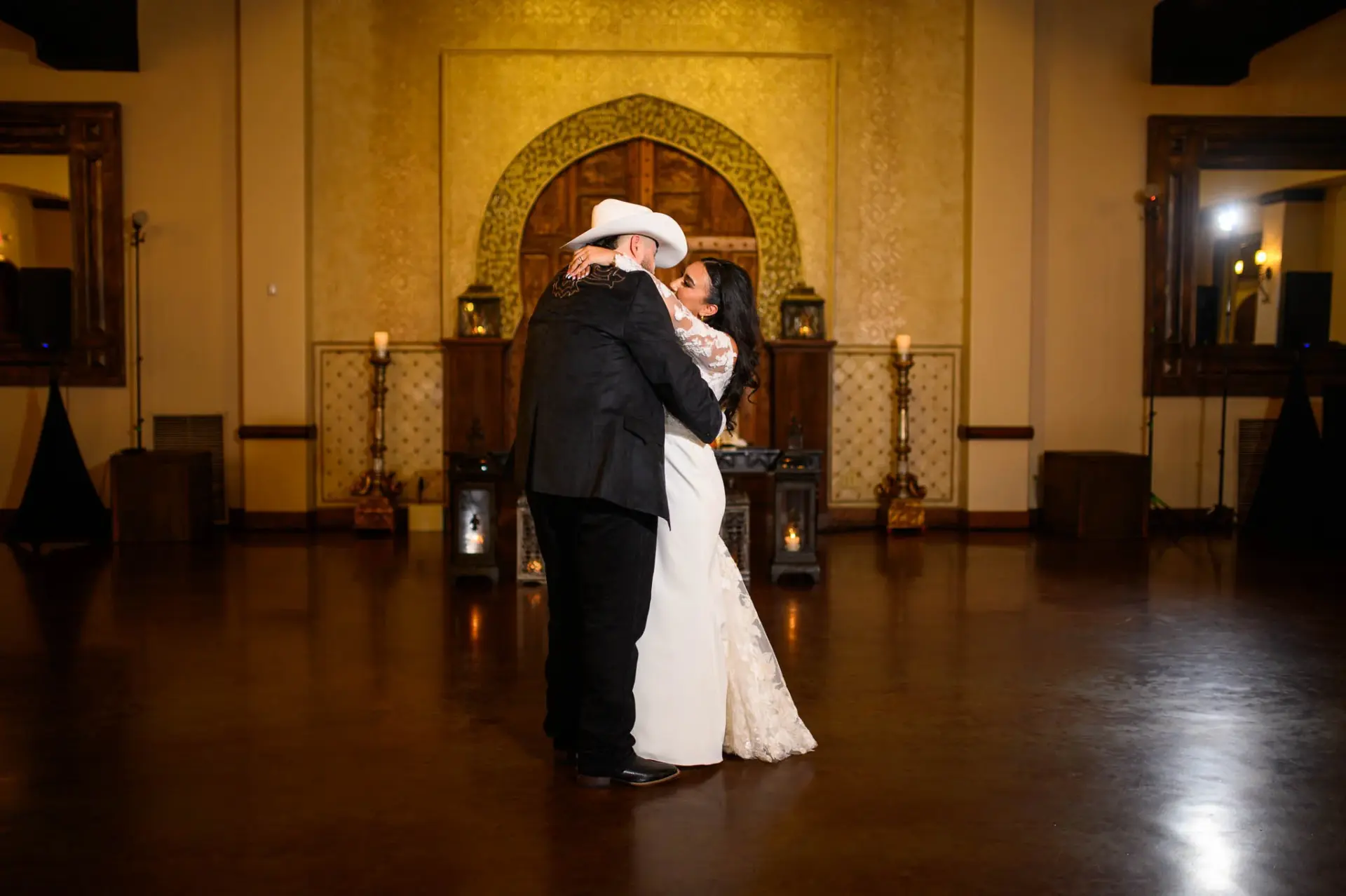 Vanessa and Reymundo dancing in the warm light of the reception room