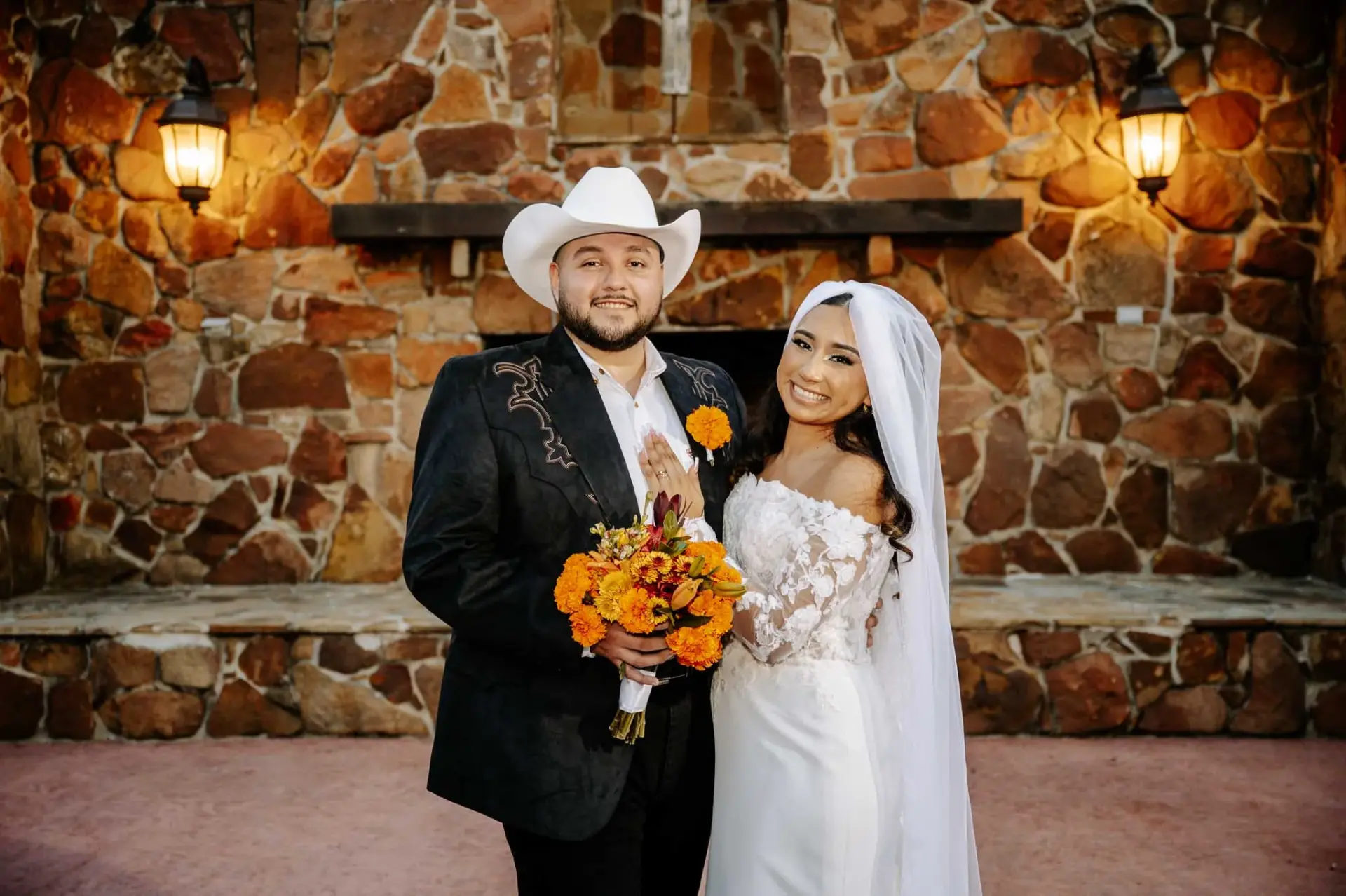Vanessa holding an orange bouquet beside Reymundo at Madera Estates