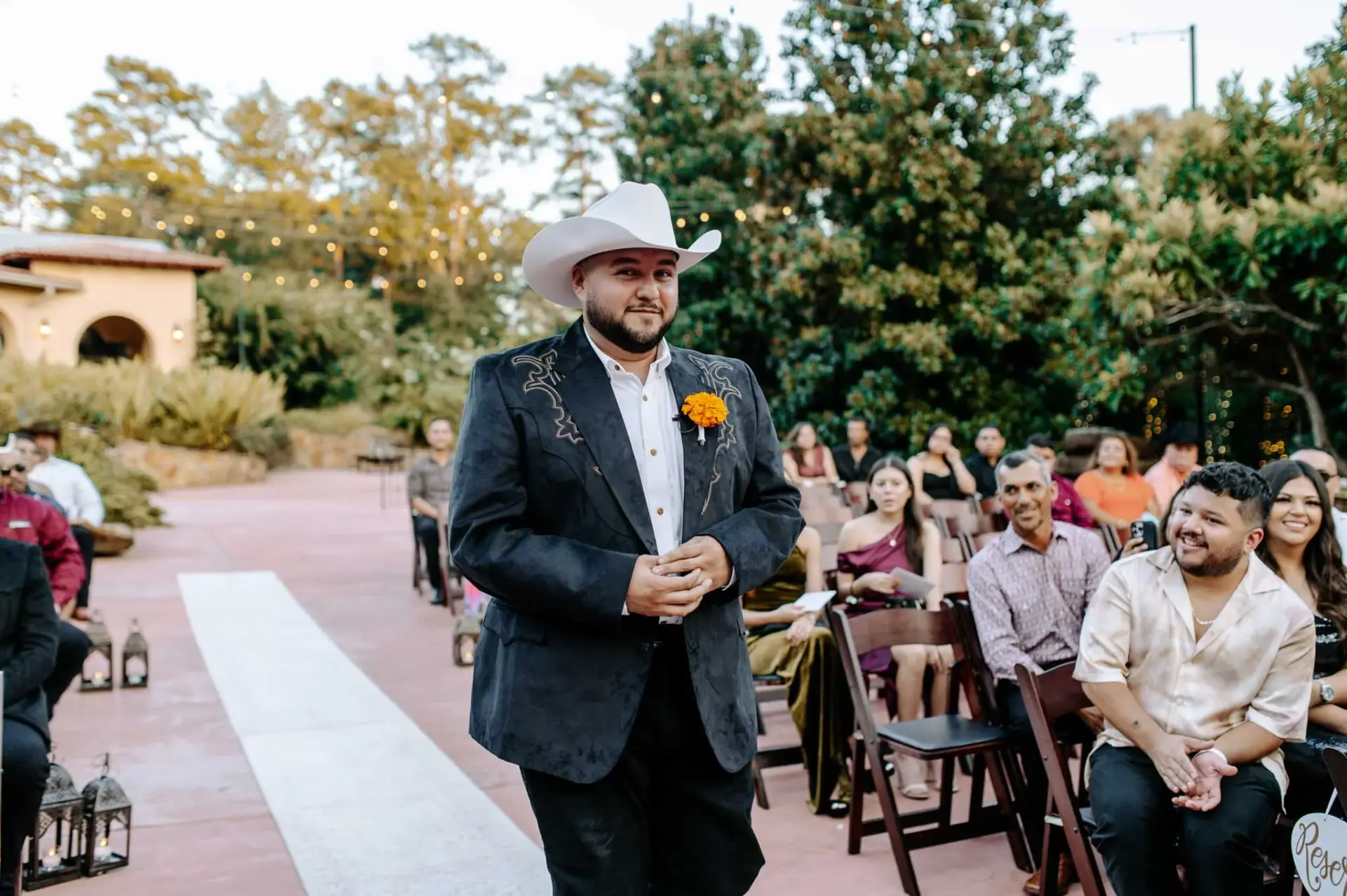 Reymundo walking down the outdoor ceremony aisle