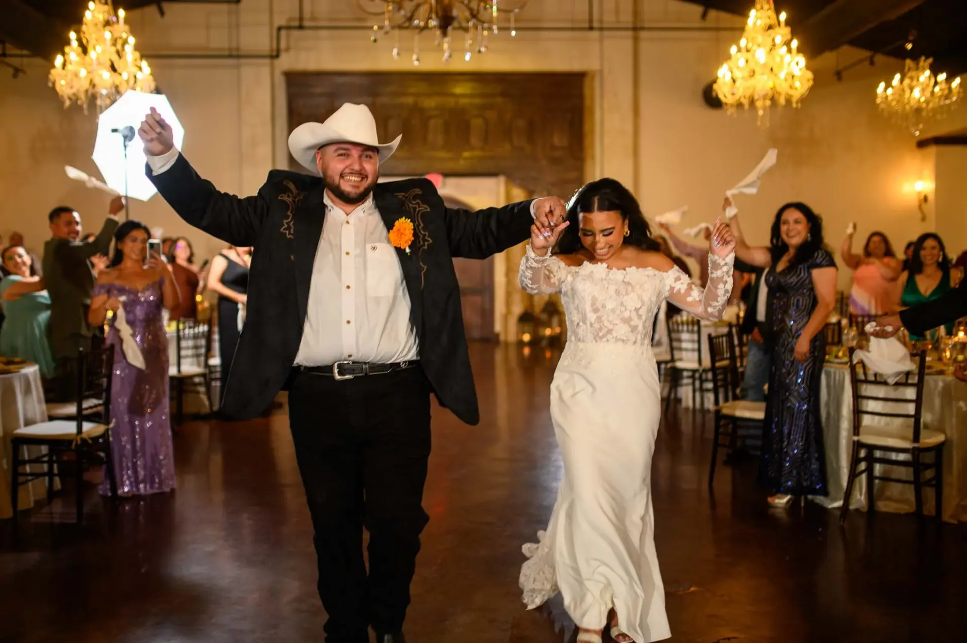 Vanessa and Reymundo entering their reception with raised hands