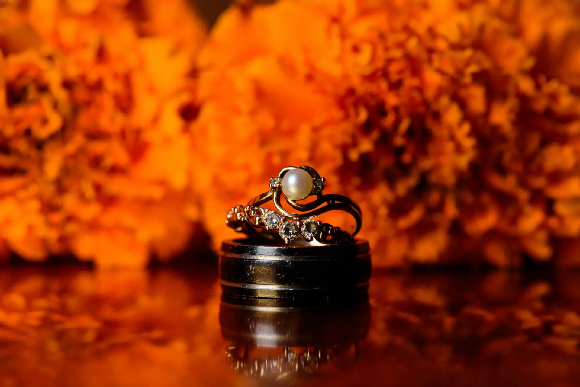 Wedding rings against a warm orange background