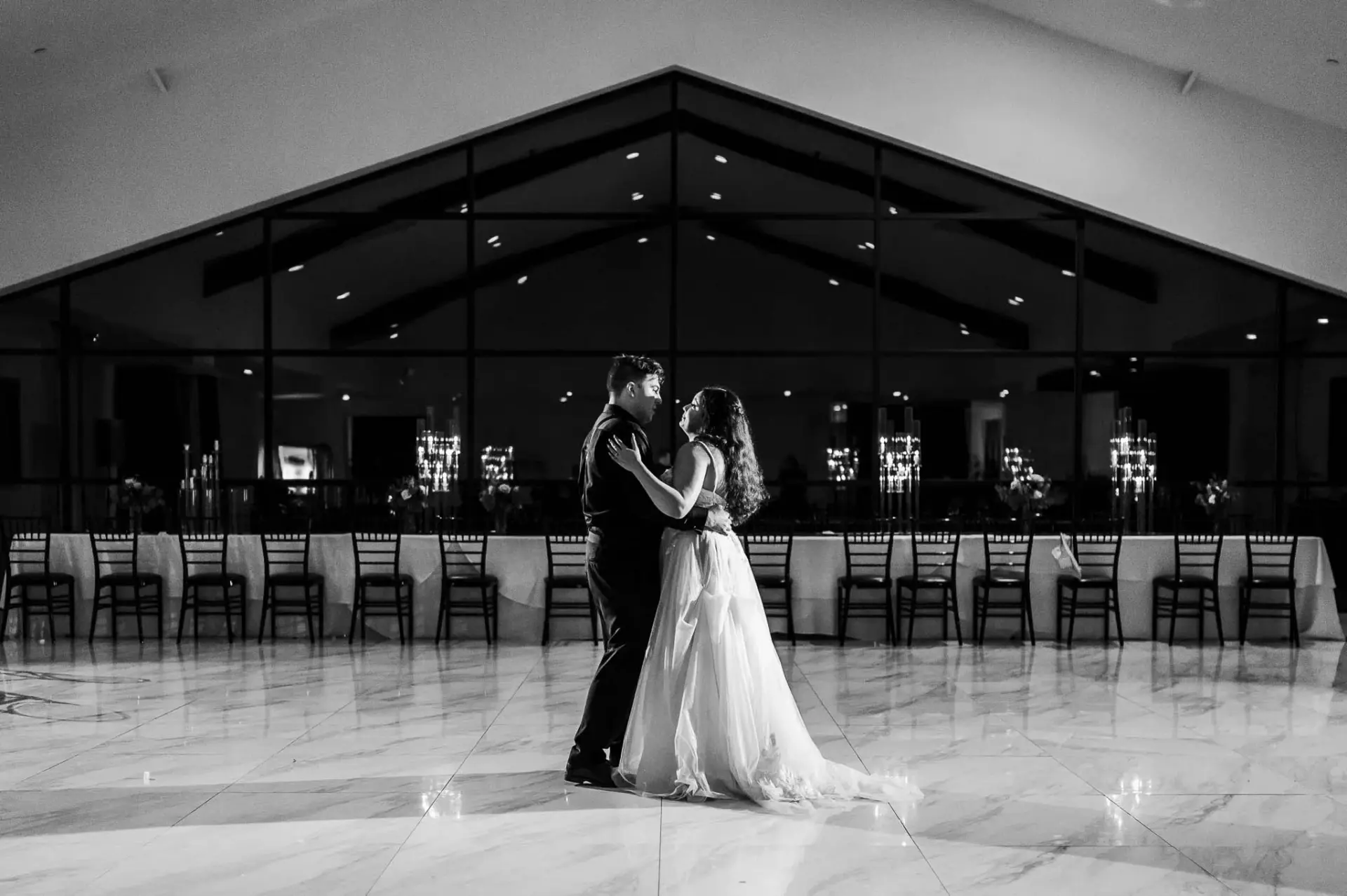 Black-and-white silhouette of Kyle and Lauren dancing in the reception hall