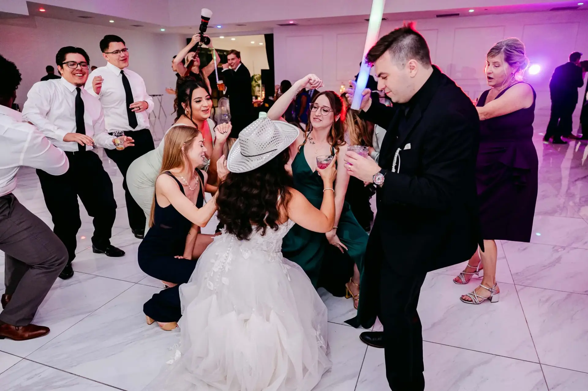 Lauren tossing her bouquet to guests on the dance floor
