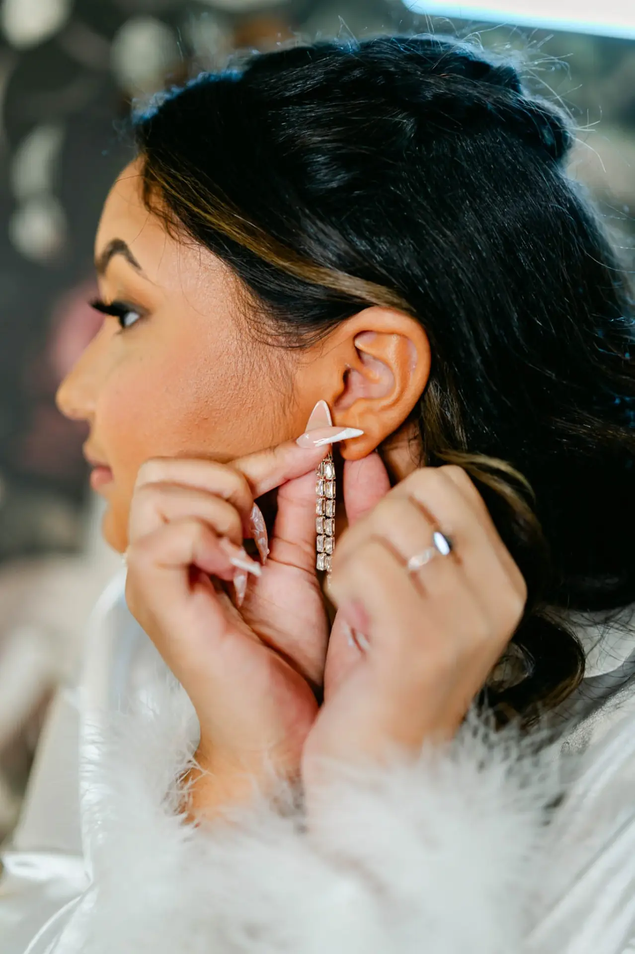 Lauren fastening a star-shaped earring before the ceremony