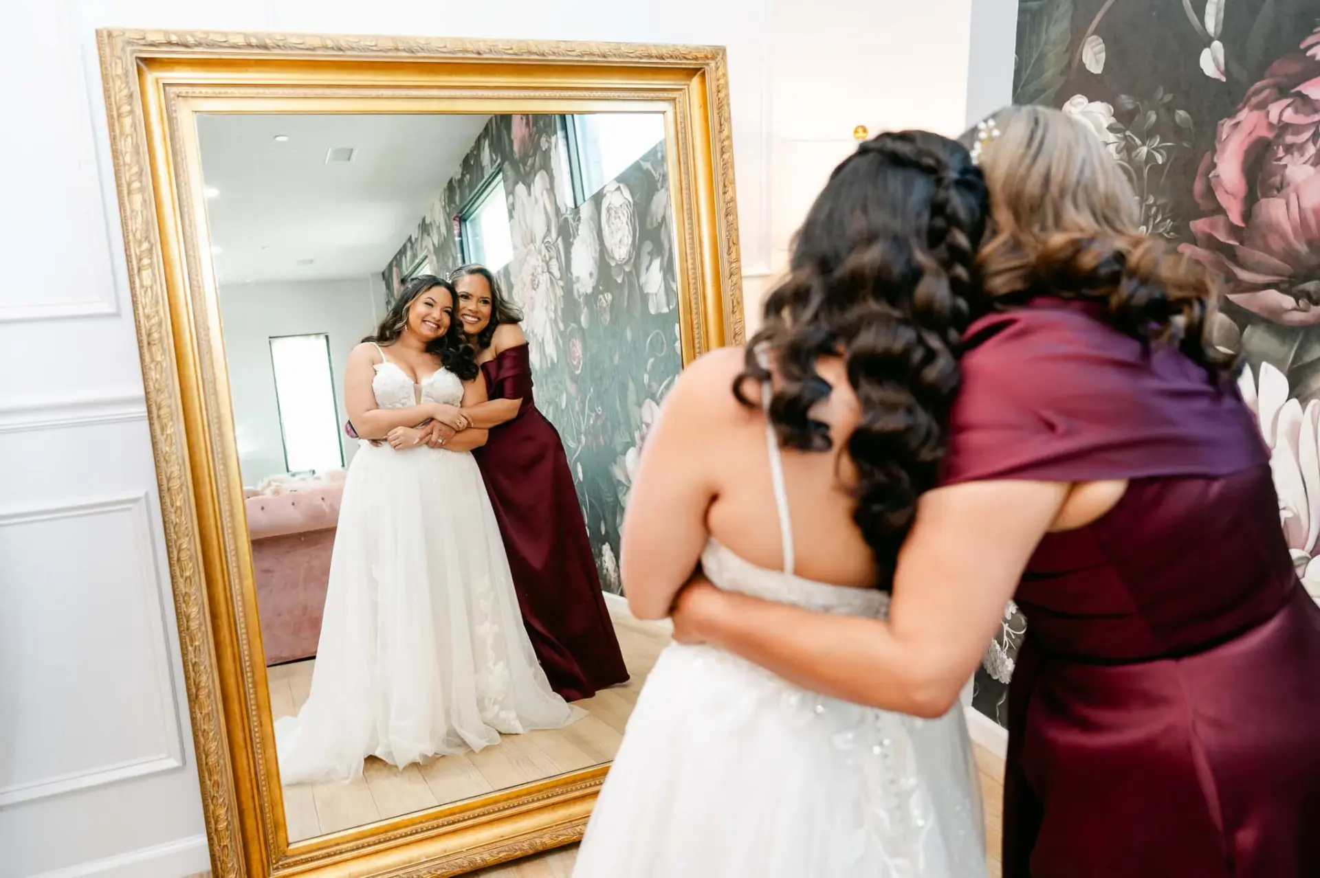 Lauren embracing her mother beside a mirror before the ceremony