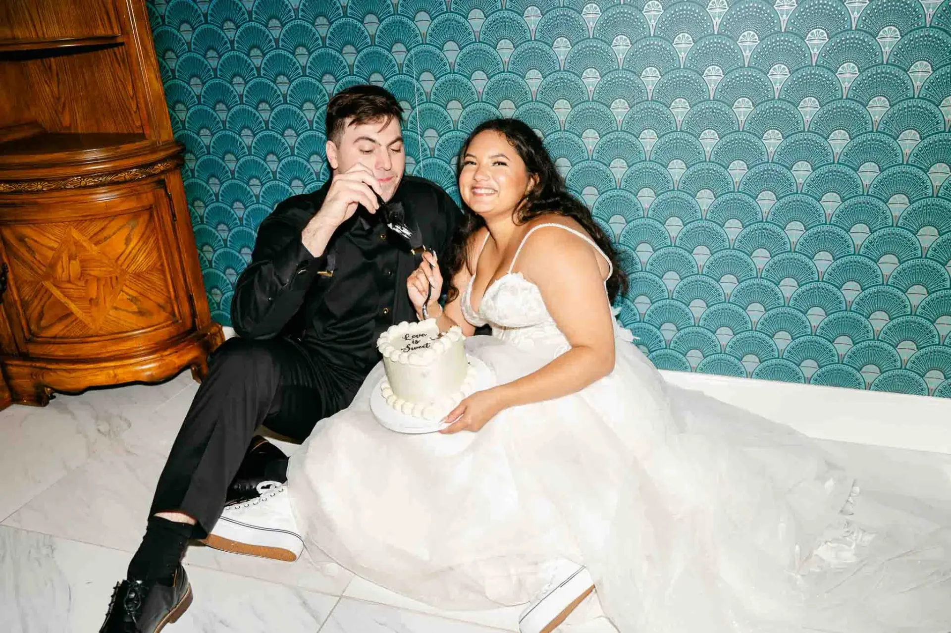 Kyle and Lauren laughing together during the cake cutting