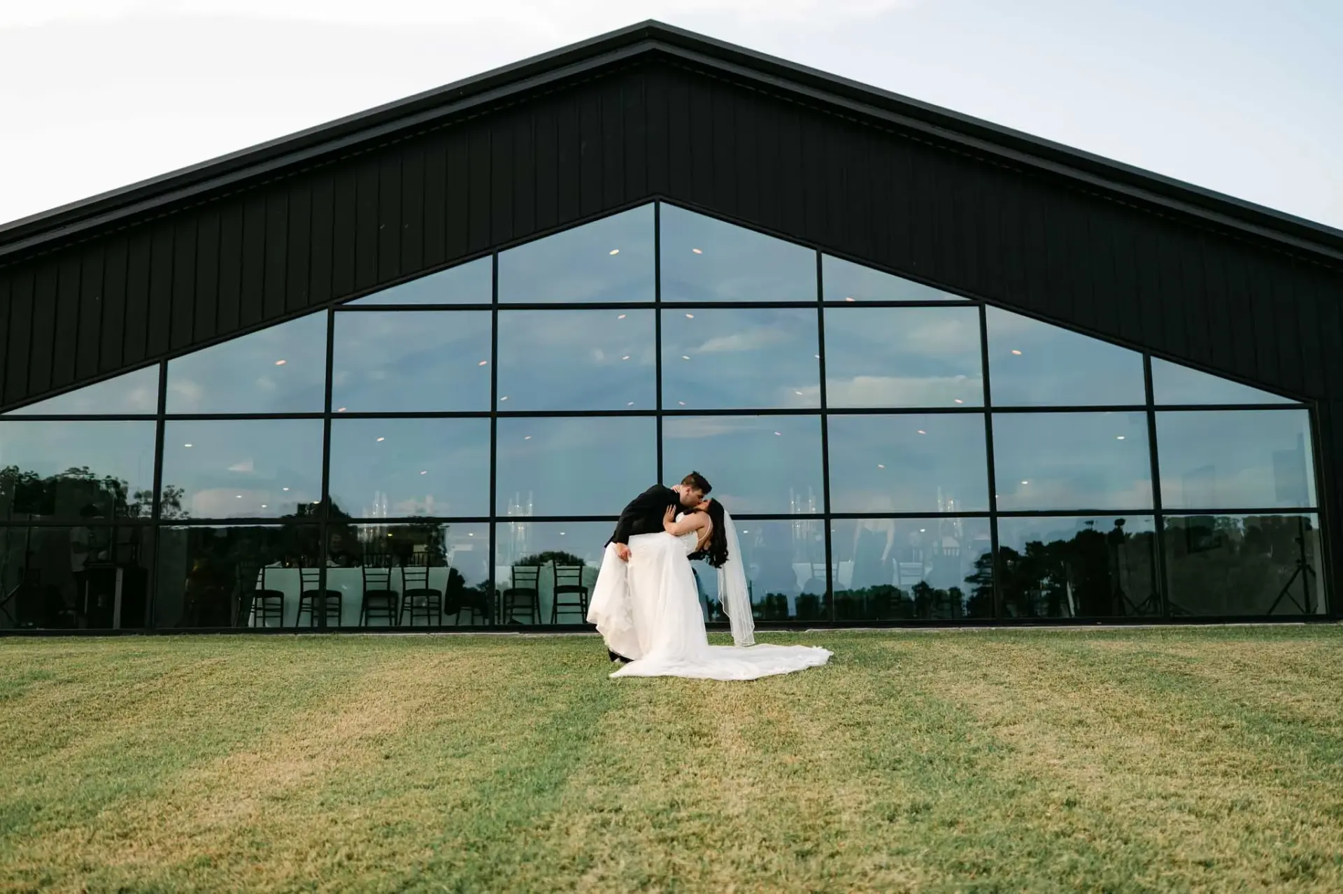 Kyle and Lauren standing together outside The Homestead’s glass-fronted venue