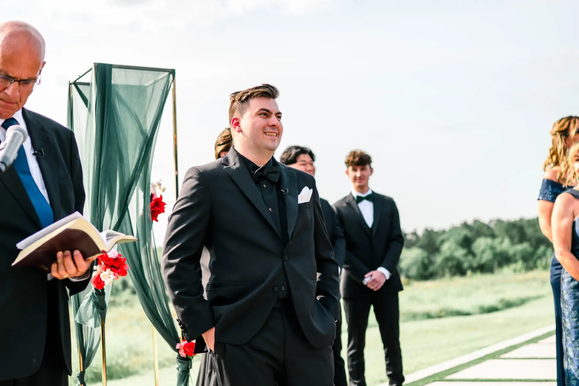 Kyle walking toward the ceremony with his wedding party