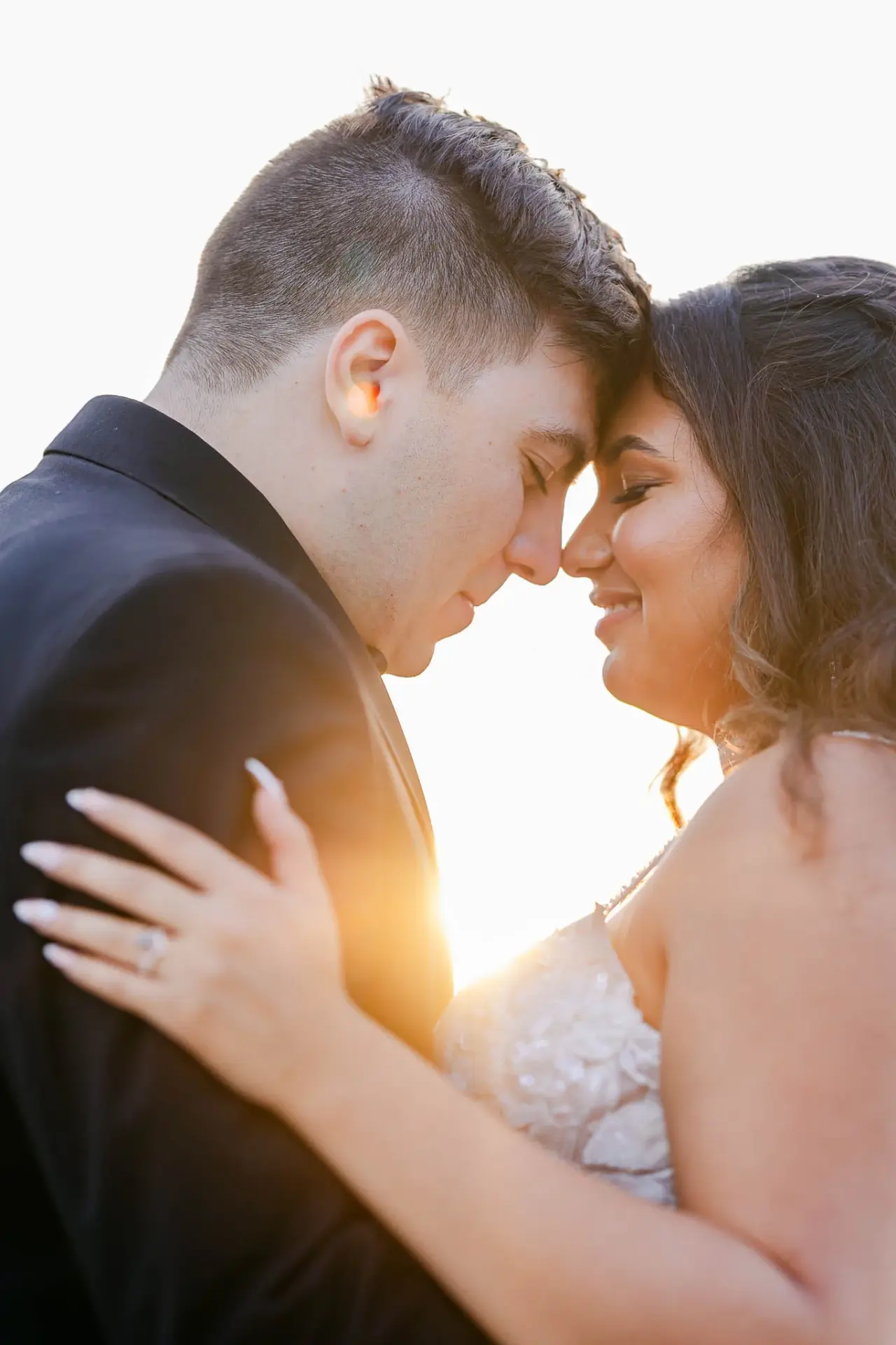 Kyle and Lauren sharing a close embrace in warm evening light
